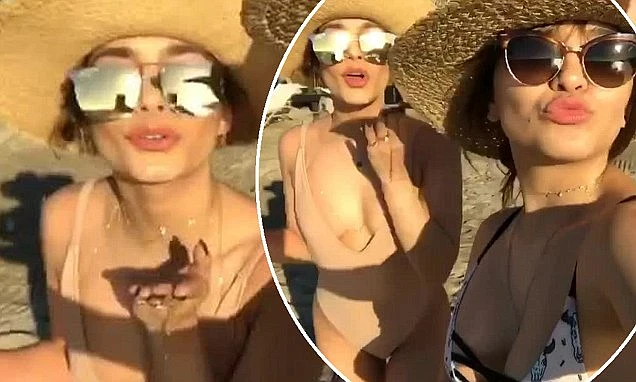 Vanessa Hudgens and sister Stella blow kisses to camera in holiday throwback video